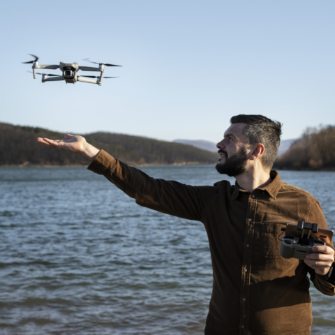 medium-shot-man-with-drone-outdoors