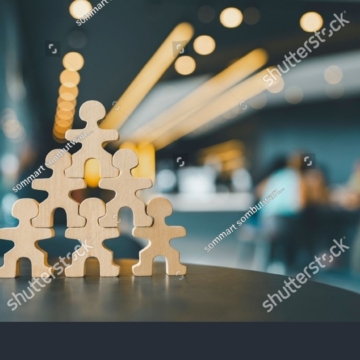 stock-photo-person-model-standing-on-another-man-who-was-an-employee-the-concept-of-teamwork-of-bosses-2494119625