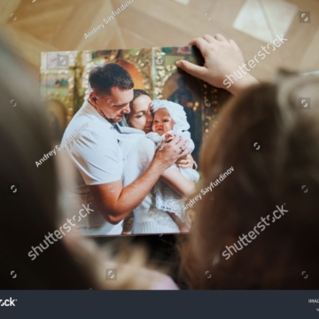 stock-photo-top-view-selective-focus-mom-and-daughter-flip-through-the-pages-of-a-photo-book-with-family-2462013517