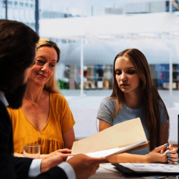stock-photo-financial-advisor-showing-clients-stock-market-trends-and-economic-indicators-on-laptop-broker-2499341181 stock-photo-financial-advisor-showing-clients-stock-market-trends-and-economic-indicators-on-laptop-broker-2499341181